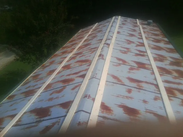 Rusted metal roof panels with new wood purlins before replacement — Storm Damage Roof Repair in Gotha by Roofing Brothers
